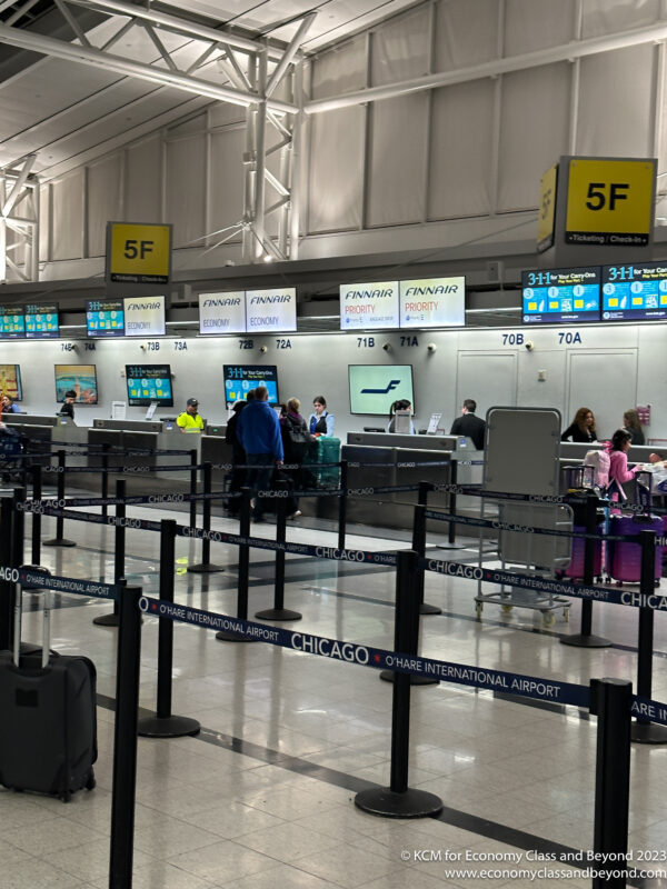 people at an airport check in counter