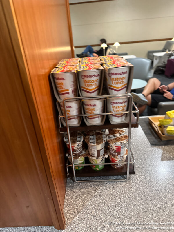a shelf with cups and food on it