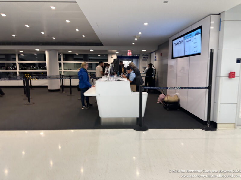 people standing in a line at a check in counter