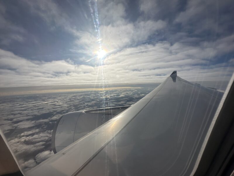 the wing of an airplane above clouds