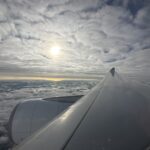 the wing of an airplane above clouds