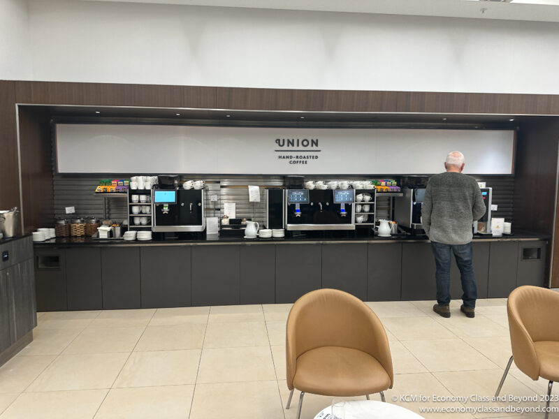 a man standing in front of a coffee machine