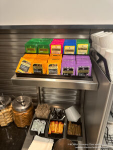 a shelf with different colored boxes and containers of food