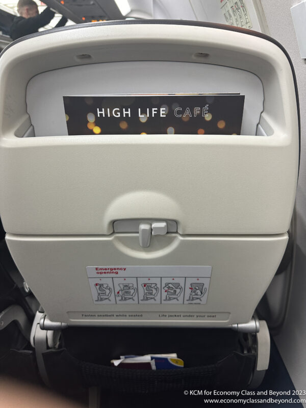 an airplane seat with a sign in it