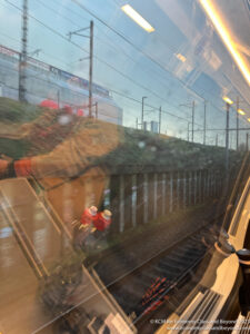 a reflection of a person on a train