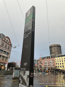 a tall black tower in a city