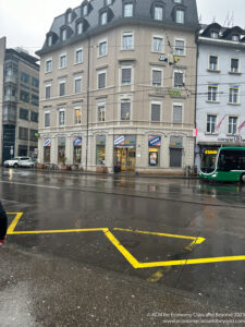 a person walking on a street in front of a building