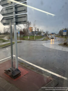 a street sign on a wet road