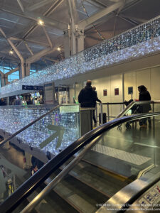 a group of people standing in a building with lights