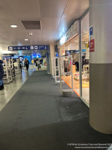 a storefront with signs and people walking