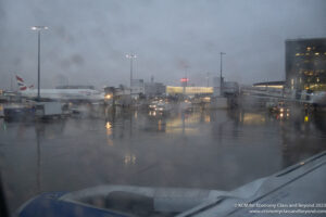 an airport with airplanes and buildings on the ground