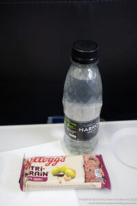 a bottle of water and a packet of cereal