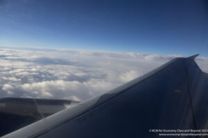 an airplane wing and clouds