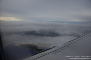 an airplane wing and clouds