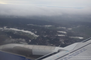 an airplane wing and a landscape