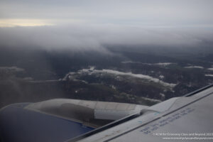 an airplane wing and a valley below
