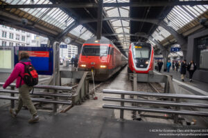 a train station with people walking around