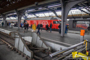 a group of people walking on a train station