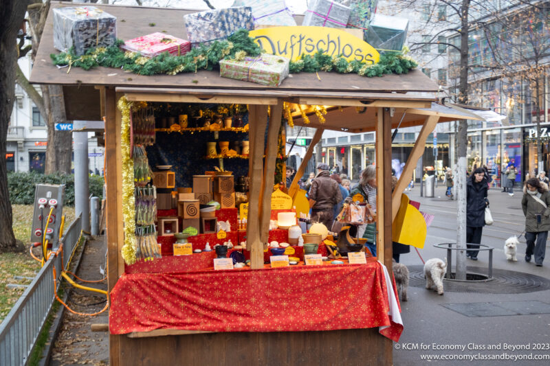 a small wooden booth with a red cloth and a red tablecloth with a yellow sign