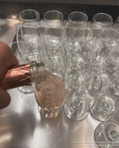 a hand pouring champagne into a glass