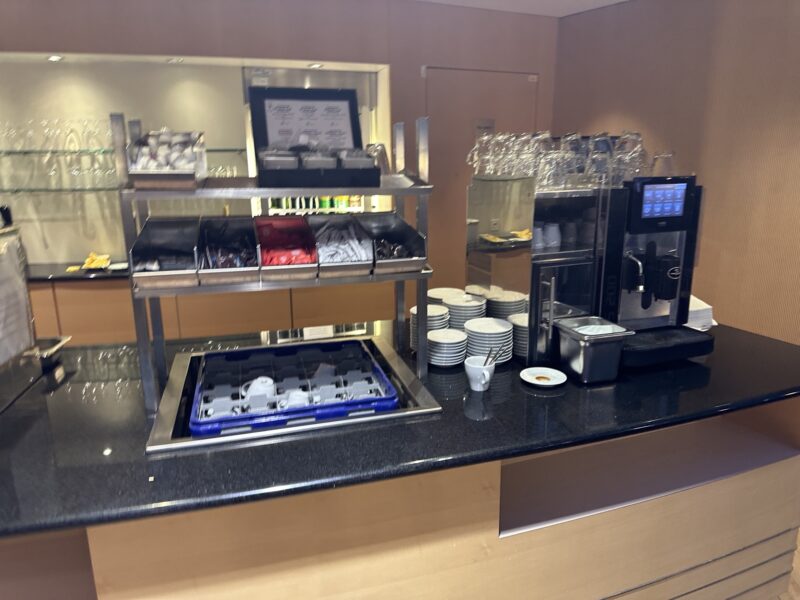 a coffee machine and cups on a counter - Europort Basel-Mullhouse-Frieburg Airport - skyview lounge