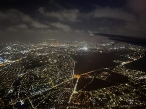 an airplane wing over a city at night