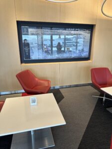 a room with red chairs and a television