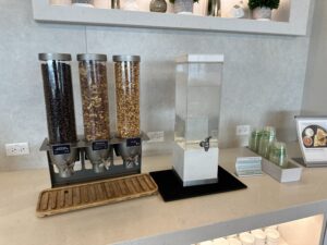 a group of cereals and water dispensers on a counter