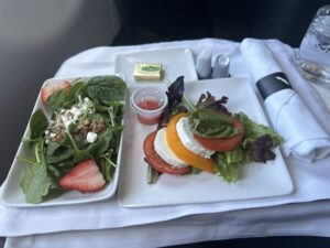 a plate of salad and cheese on a table