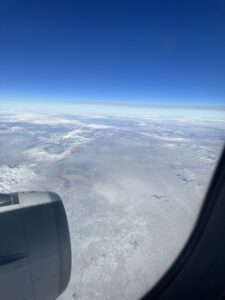 an airplane window overlooking a snowy landscape