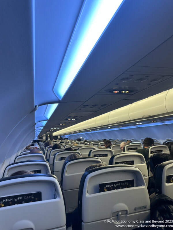 a plane with people sitting in the seats