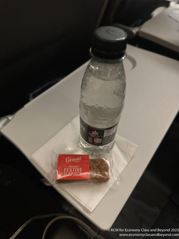 a bottle of water and a snack on a table
