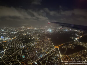 an airplane wing and city lights at night