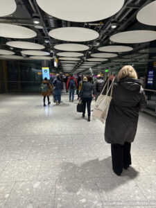 a group of people walking in a subway