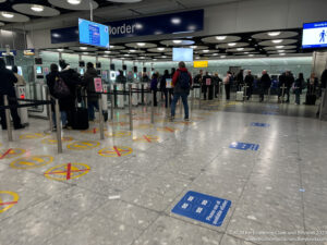 people standing in a line at an airport