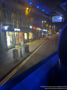 a view of a street from a car window at night