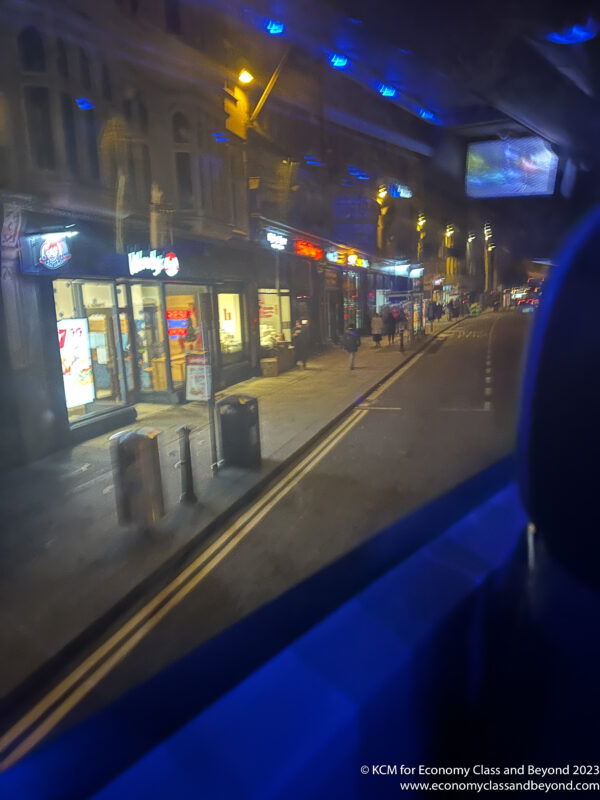 a view of a street from a car window at night