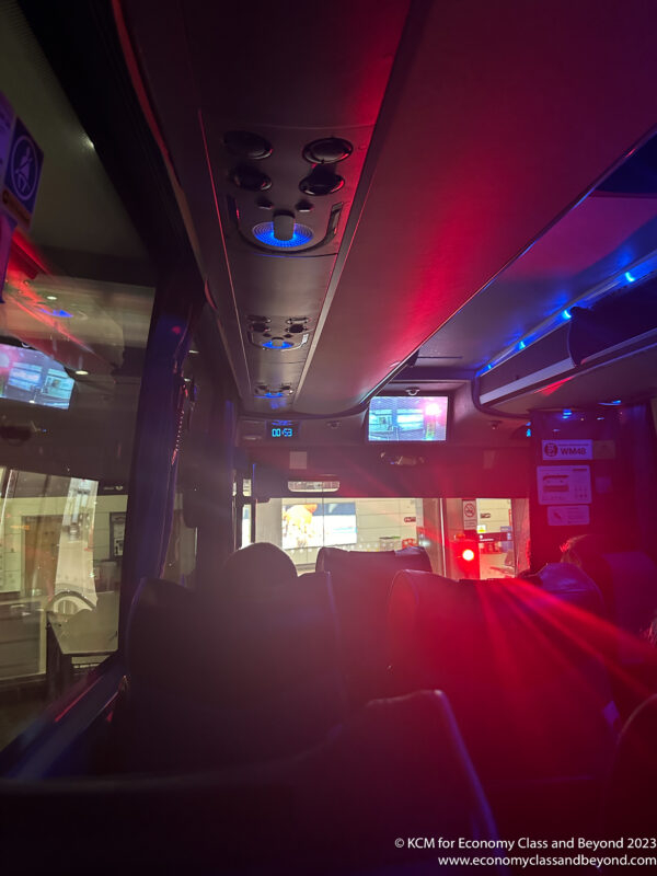 inside a bus with lights and seats