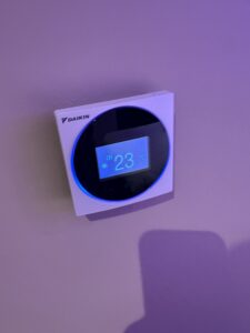 a digital thermostat on a wall