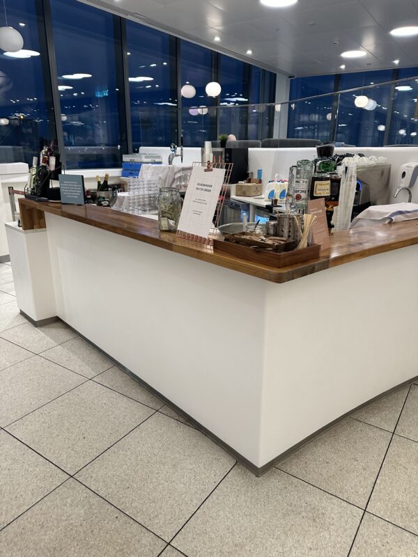 a white counter with a wood counter and a wood counter with a wood counter and a white tile floor