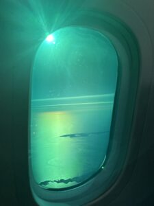 a window with a light shining on the water