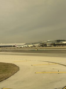 an airport runway with buildings in the background