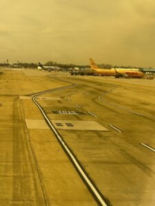 an airport runway with airplanes on it