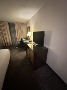 a room with a television and a lamp