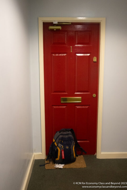 a red door with a backpack