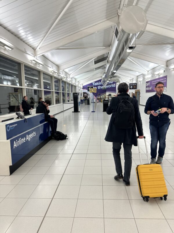 a man and woman with luggage in an airport