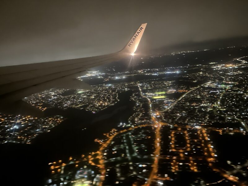 an airplane wing with lights in the sky