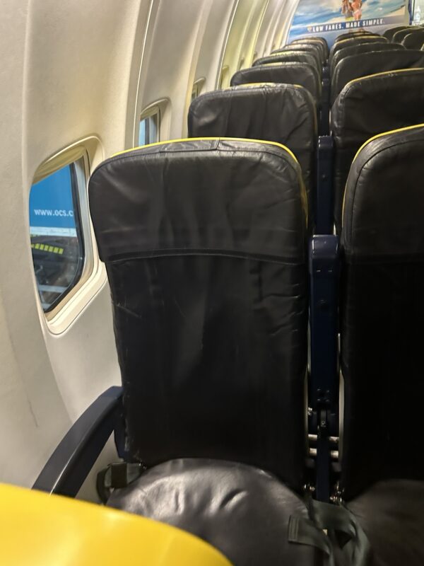 a row of black seats on an airplane