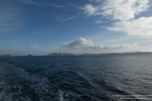 a body of water with a city in the distance