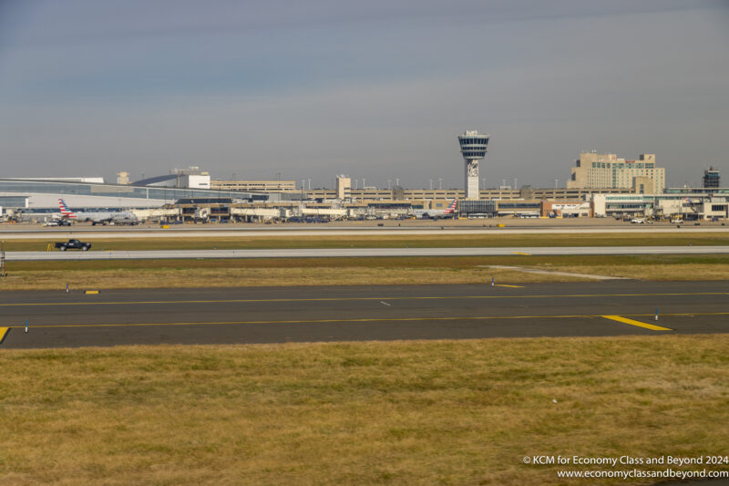a runway with a tower in the background